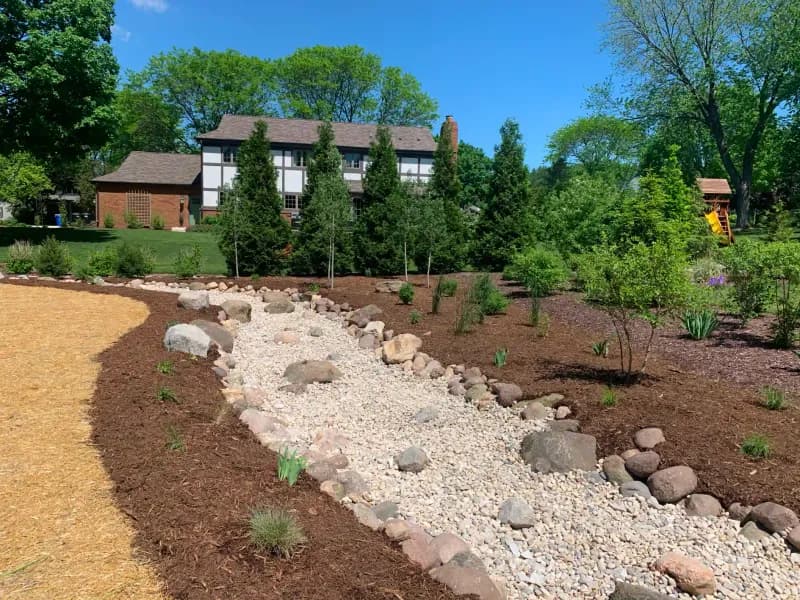 Dry river bed drainage swale with new plantings