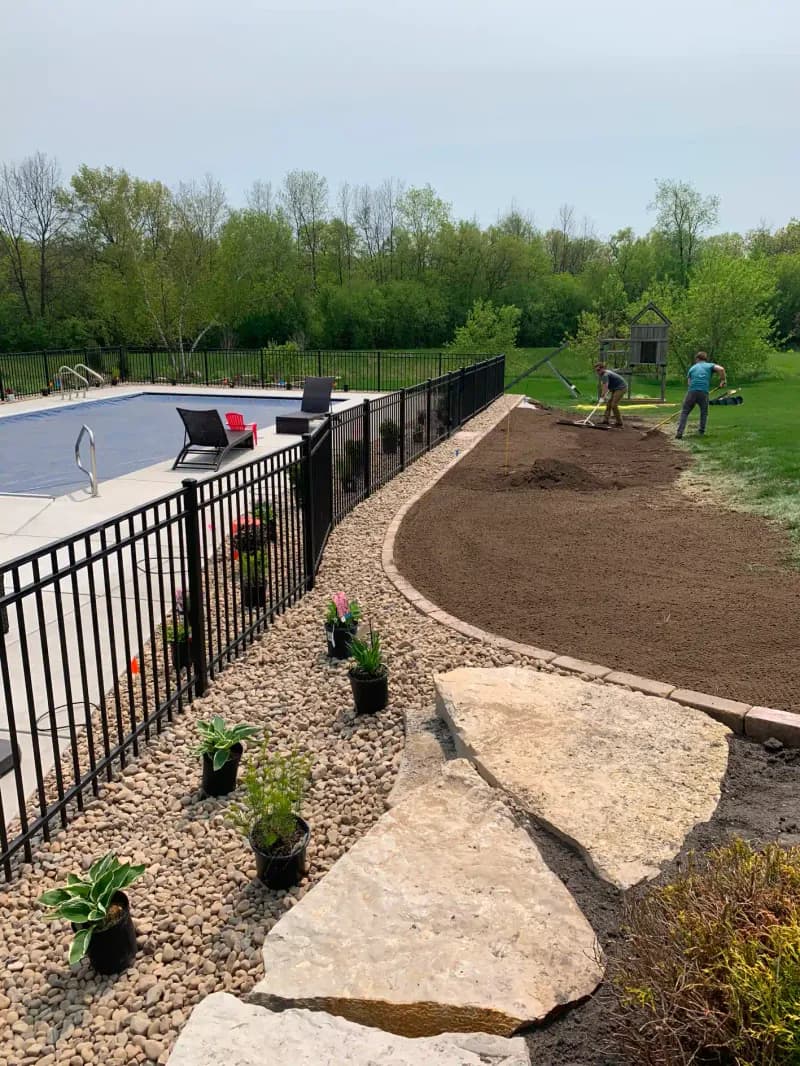 Pool area grading with river rock planting bed and stepping stones